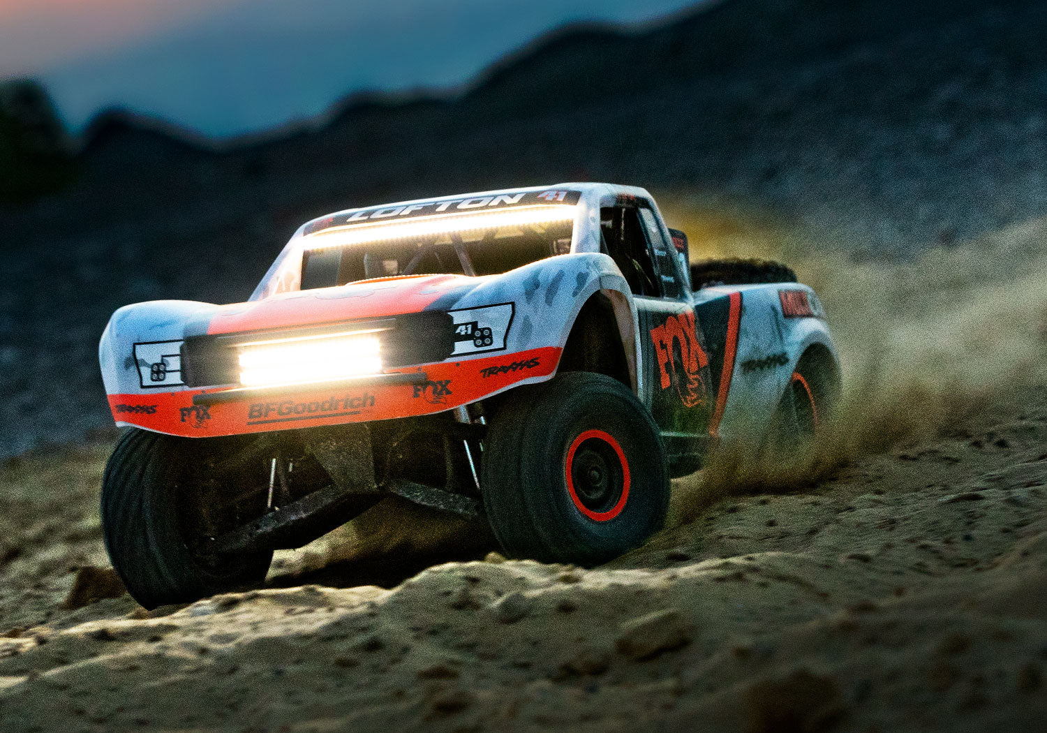 An action shot of the 1/7 Unlimited Desert Racer Ready to Run (Fox) (TRA85086-4-FOX).